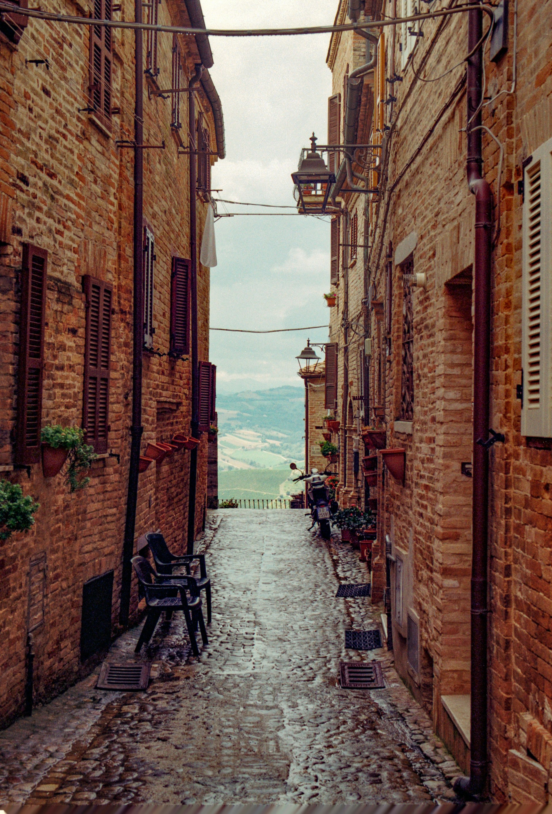 Narrow alley with panoramic view over the Marche hills